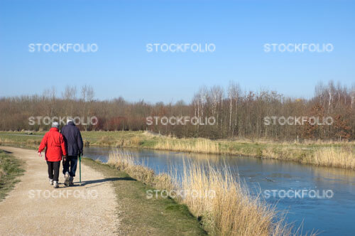 Senior couple walking along a canal towpath