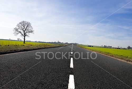 Open road stretching out to the horizon with diminishing perspective