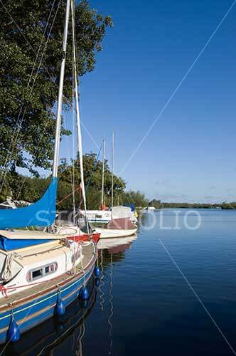 Yachts moored on a blue lake
