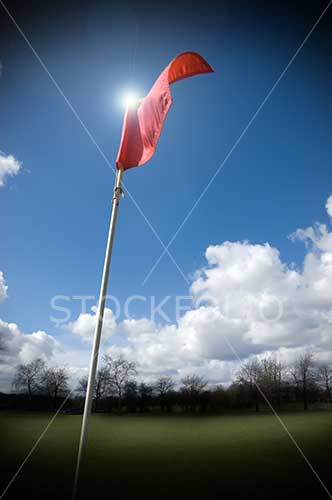 Red flag on a gold course fluttering in the wind